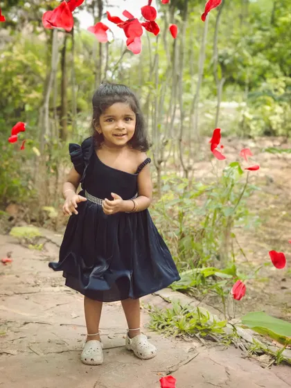 A magical moment with falling rose petals. We love adding a touch of fun and fantasy to our outdoor children's photoshoots.