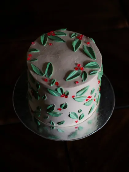 A moody, dark shot of my holly-painted Christmas cake. The simple elegance of this design makes it one of my favorites for the holiday season.