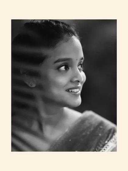 A beautiful black and white portrait of a bride, her smile and profile captured in a soft, timeless light.