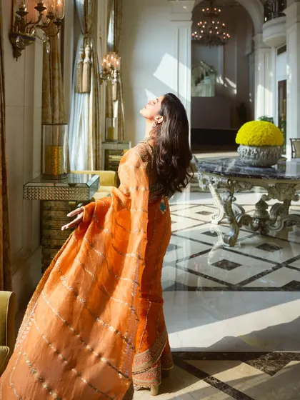 A dramatic and artistic shot showcasing the flow of the saree and the radiant makeup. The look was designed to feel dynamic and full of life, perfect for a professional photoshoot.
