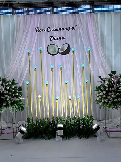 Another view of the Roce Ceremony stage, highlighting the soft lighting and the symmetrical arrangement of the floral bouquets.