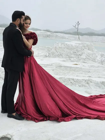 A romantic couple's shot featuring our dramatic red trail gown. This is the kind of image that sells a pre-wedding photography package, and our gown is the centerpiece.