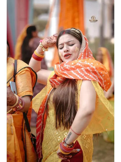 A candid shot of the bride dancing with joy during her Haldi ceremony. We capture the energy and happiness of these moments.