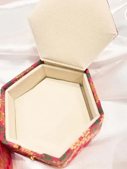 The interior of the hexagonal jewelry box, showing the soft lining designed to protect precious items.