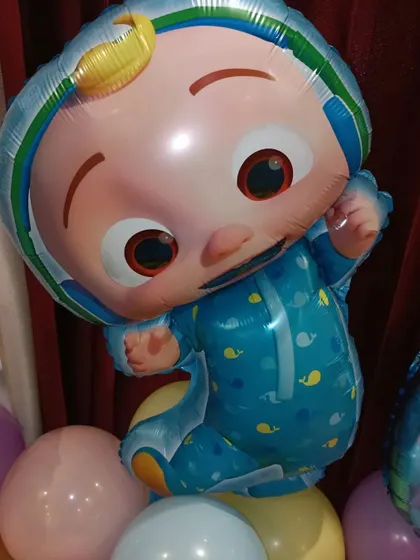 Detail of the JJ character foil balloon used in the home party setup.