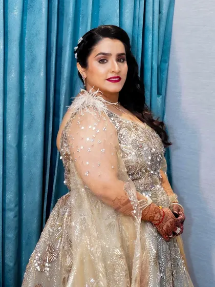 A side profile showing the elegant hairstyle and the radiant makeup. This look is pure bridal glamour.