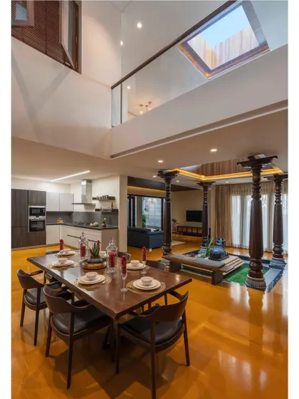 The dining area and courtyard sit under a large skylight, connecting the home to the sky and filling the open-plan space with natural light.