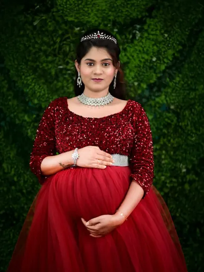 A classic portrait of an expecting mother in our elegant red sequin gown. We provide alterations to ensure a perfect fit for your maternity shoot.