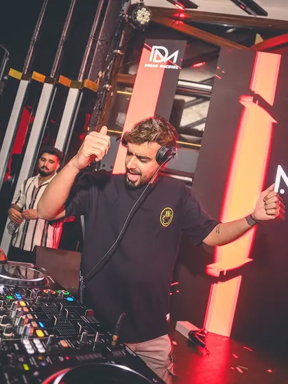 A thumbs-up and a big smile from the DJ booth. My goal is simple: to make you smile and dance with my music.