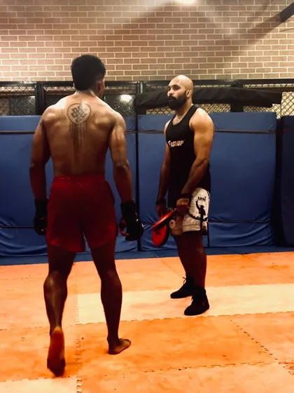 365 days a year, we put in the work. A coach and student facing off before a drill.