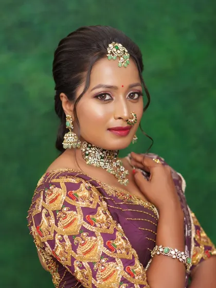 A close-up of the reception look, focusing on the eye makeup and jewelry.