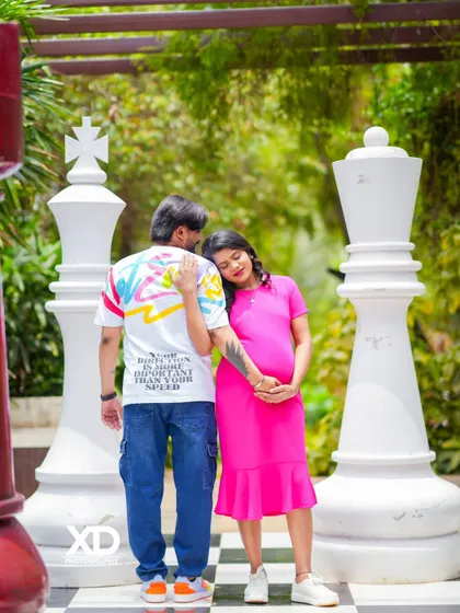 A playful and unique maternity shot on a giant chessboard. This creative setting adds a fun and memorable element to your modern pregnancy photoshoot.