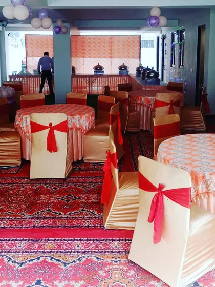 Another angle of the event setup, showing the coordinated chair covers and table linens that my team arranged to match the client's theme.