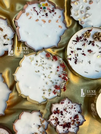 A beautiful flat-lay of my various Urli candles, showing the different shapes and toppings available, from spices to dried flowers and gold foil.