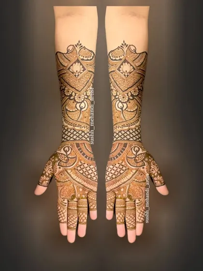 This design showcases a unique flow, with paisley and floral patterns weaving up the arms. It's a modern take on a full bridal mehandi.