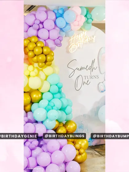 A close-up of the pastel balloon garland, showing the beautiful blend of purple, yellow, teal, and gold.
