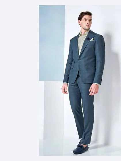 Every gentleman has a love affair with a well-tailored suit. This teal two-piece suit, crafted from fine fabrics, is a testament to that timeless relationship.