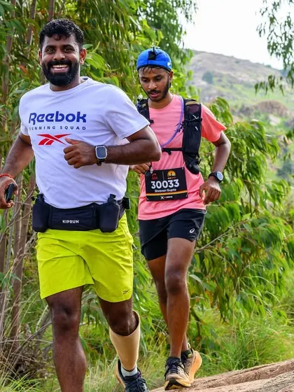 Running alongside one of my athletes during a trail race. We push each other to be our best.