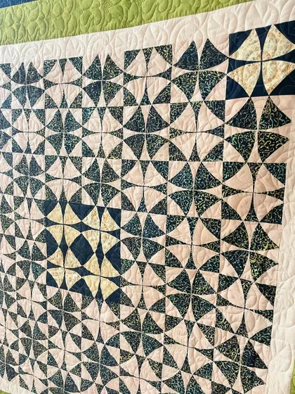 A detail shot of the "Wheel of Mystery" quilt, showing the curved quilting.