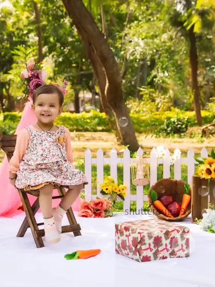 Bubbles add a touch of magic to this beautiful outdoor portrait of a toddler sitting in her chair.