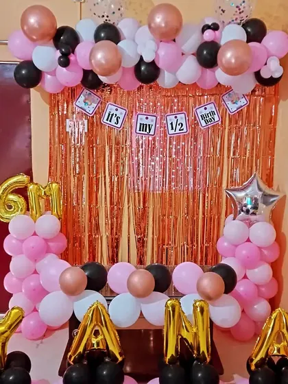 A clear shot of the half-birthday setup with name and '6M' foil balloons.