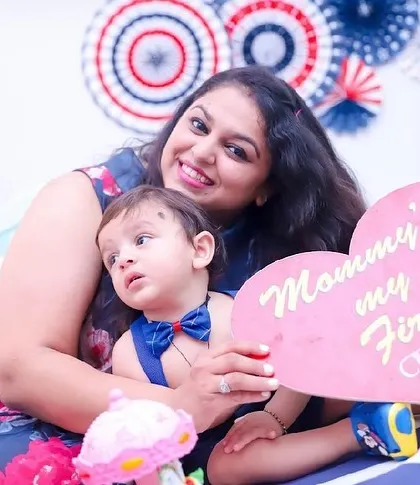 "Mommy's my First Love". A mother and son pose with a cute sign during his studio photoshoot.