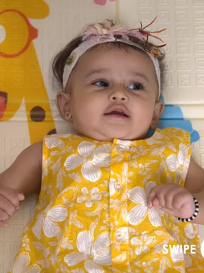 A precious moment with a baby girl wearing our sunny yellow floral jhabla. The front-button design makes it easy to dress even the wiggliest of babies.