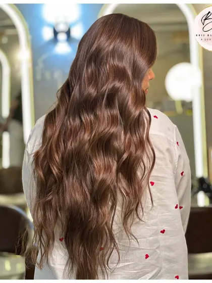 Another view of this luminous brown transformation. The waves perfectly showcase the rich tones and incredible, healthy-looking shine.