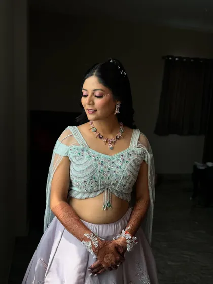 A serene portrait of the bride. The soft pastel colours of her outfit are reflected in her light and airy makeup.