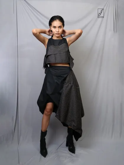 A powerful, symmetrical pose that confronts the camera directly, showcasing both the model's confidence and the outfit's design.