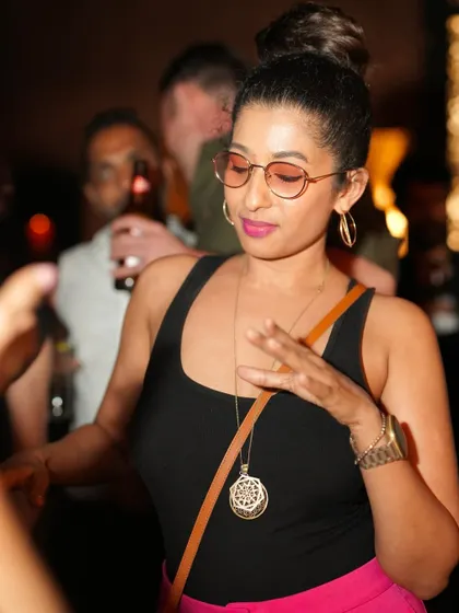 A guest dancing with style, adding to the cool and fashionable vibe of the rooftop party.
