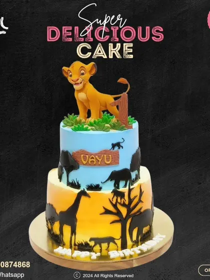 A majestic Lion King cake for a wild celebration. This two-tier design showcases a beautiful sunset safari silhouette on the bottom and a proud Simba on top, personalized with the birthday boy's name.