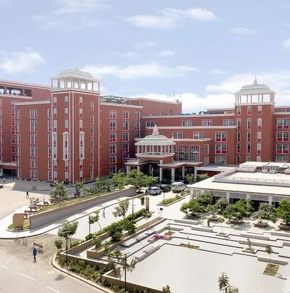 Sharda Care Healthcity is a world-class medical facility designed to enhance healthcare accessibility. The grand facade and organized entry plaza reflect the project's significant scale and its role in the region's medical ecosystem.