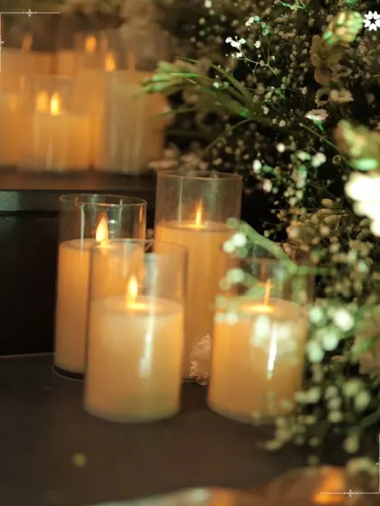 The soft, warm glow of candles nestled amongst baby's breath. We use lighting as a key element to create a dreamy and romantic atmosphere, transforming the space as day turns to night.