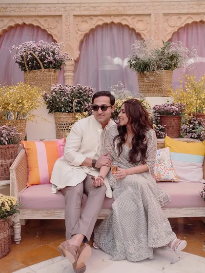 The happy couple at their sunlit welcome lunch and Mehendi at Suryagarh. The courtyard was transformed into a floral wonderland, perfect for an afternoon of champagne, laughter, and celebration.