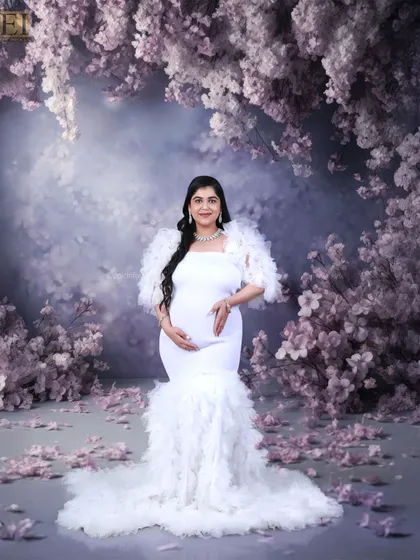 A winter wonderland feel with a white feathered gown set against a backdrop of frosty purple flowers.