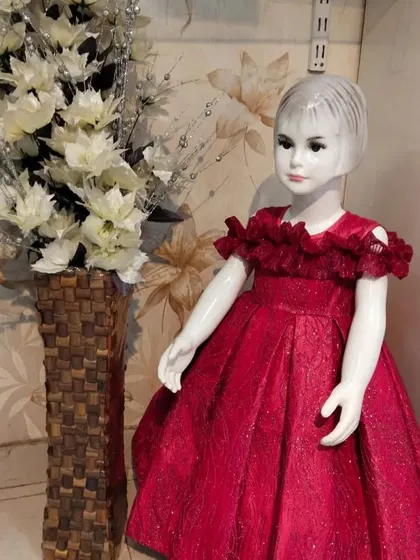 This is a half-shoulder box-pleat gown in a shimmery red fabric, perfect for a Christmas party or formal event.
