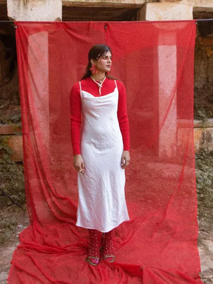 The 'LUNA' look styled without the hat, focusing on the simple elegance of the layered dress and sweater.