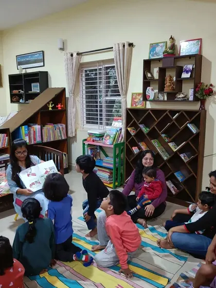 The children look up with excitement as the paper dolls go on an adventure around the room.