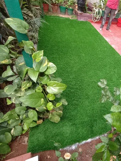 The same garden lawn, viewed from another angle. The artificial turf is a practical way to have a green lawn in a heavily shaded area where real grass struggles to grow.
