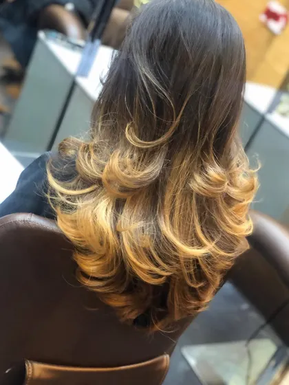 Another angle of the golden ombre style, showcasing the layered cut that complements the colour.