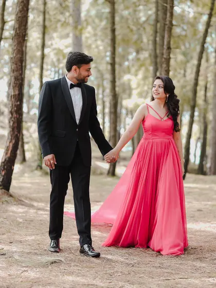 A classic romantic portrait of a couple holding hands and sharing a look of love during their forest pre-wedding shoot. This is a timeless image that every couple treasures.