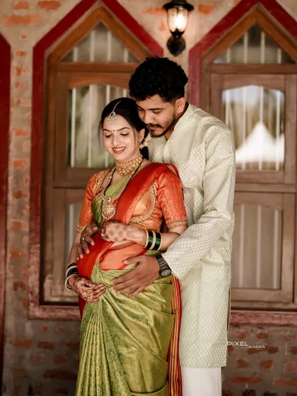 An intimate portrait of the expecting couple. Her makeup is soft and natural, perfect for these close-up, personal moments.