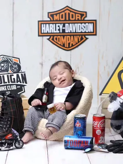 Born to be wild! This Harley-Davidson biker theme is a fun and edgy choice for a newborn shoot, complete with a tiny helmet, boots, and other cool props.