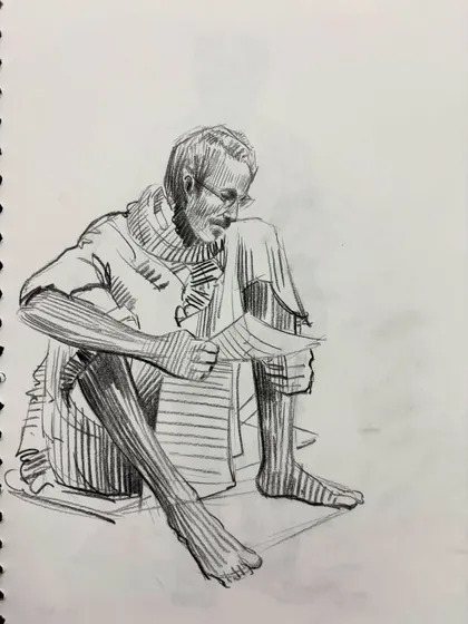 A sketch of a man reading, capturing a quiet, focused moment.