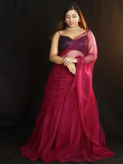 A full-length shot with the model looking down, creating a soft and elegant mood. The simple background keeps all the attention on the outfit.