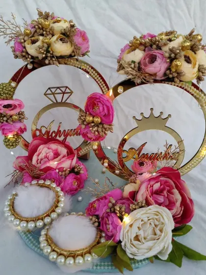 A stunning floral ring platter with custom acrylic name cutouts and LED lights. It's designed to hold the engagement rings in a beautiful display.