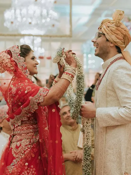 The playful and joyous struggle during the Jaimala ceremony. We love capturing these candid moments of fun that are just as important as the grand, planned spectacles.