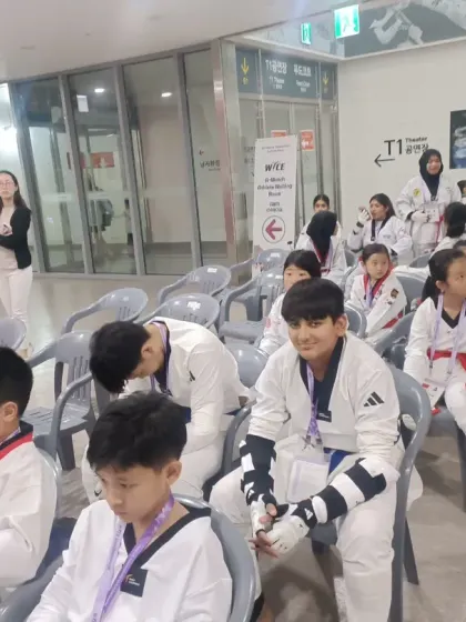 My students waiting patiently for their event to begin, surrounded by competitors from other nations.