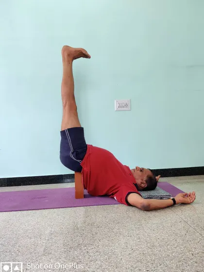 Viparita Karani (Legs-Up-the-Wall Pose) with a block for support under the sacrum. This is a simple, restorative inversion that calms the nervous system.